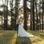 Bride and groom embracing in the forrest - Brooke Jackson