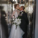 Bride and groom in mirrored elevator - Brooke Jackson