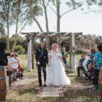 Bride and groom walking down isle - Brooke Jackson