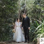 Bride and groom walking on path - Brooke Jackson